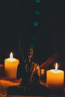 Buddha image with candles representing purity and enlightenment.